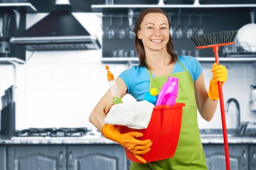 Cleaner sanitising a Soho kitchen during a move-in clean