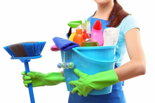 Local cleaning team working in a Soho apartment building with narrow access